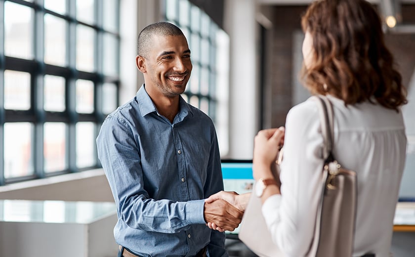 Man and woman shaking hands in an office 