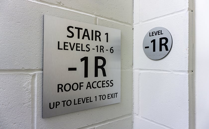 Stairway wayfinding sign, level 1R on wall 