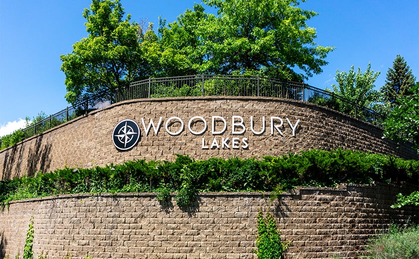 Woodbury Lakes exterior signage on a brick wall