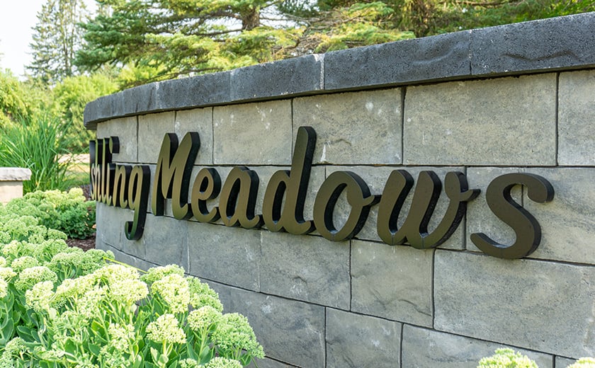 Residential building complex signage on brick sign 