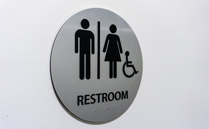 Ada compliant restroom wall sign with braille