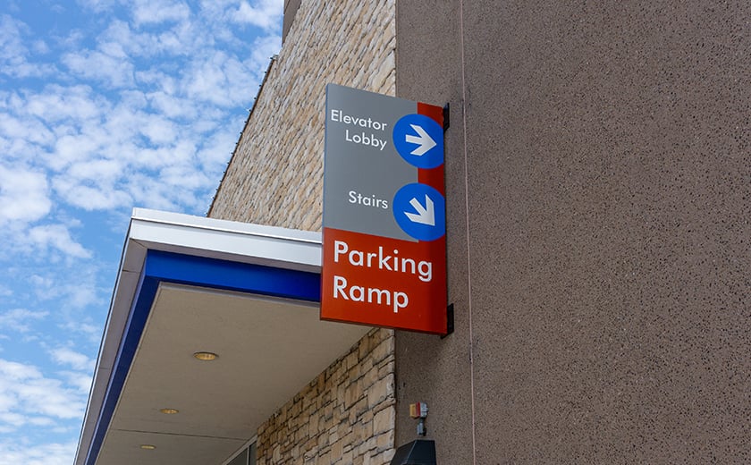 Parking ramp directional signage on a building wall