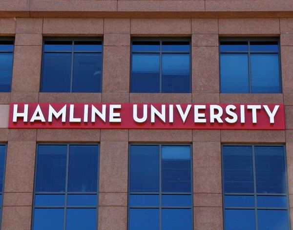 Hamline University custom school sign on the side of a campus building.